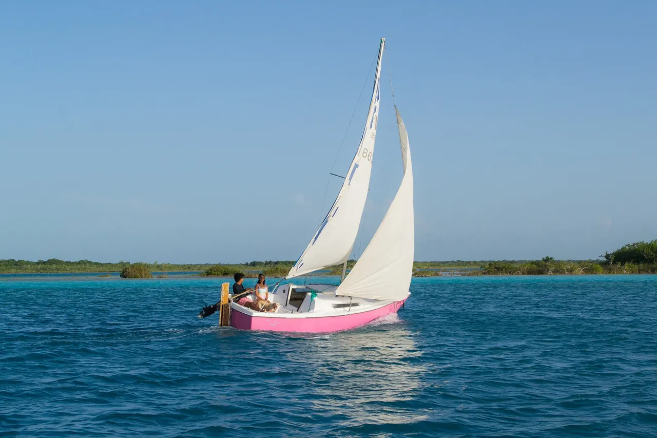 Sailboat on the blue water of Bacalar lagoon