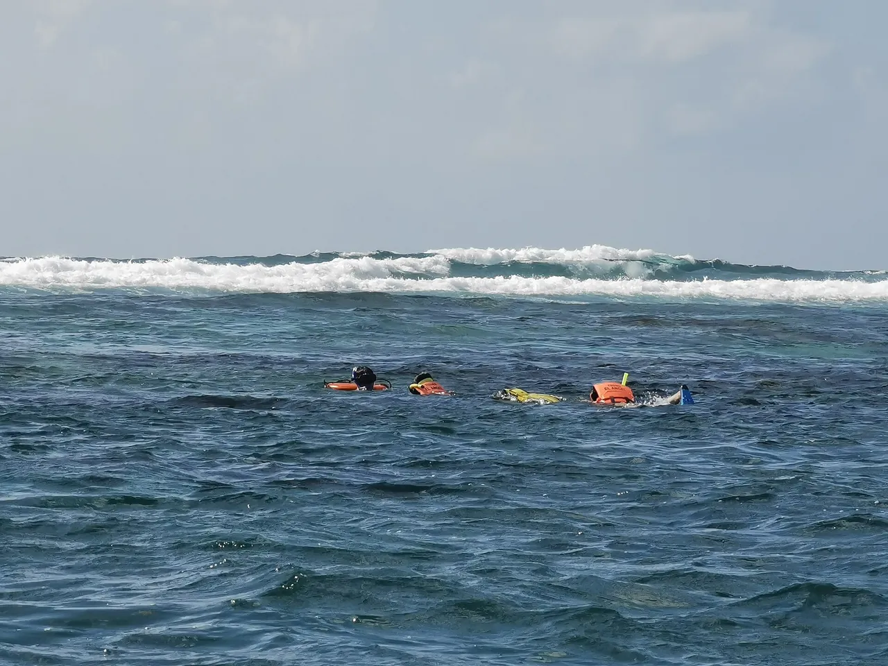 Group of people in life vests snorkeling on the Puerto Morelos reef