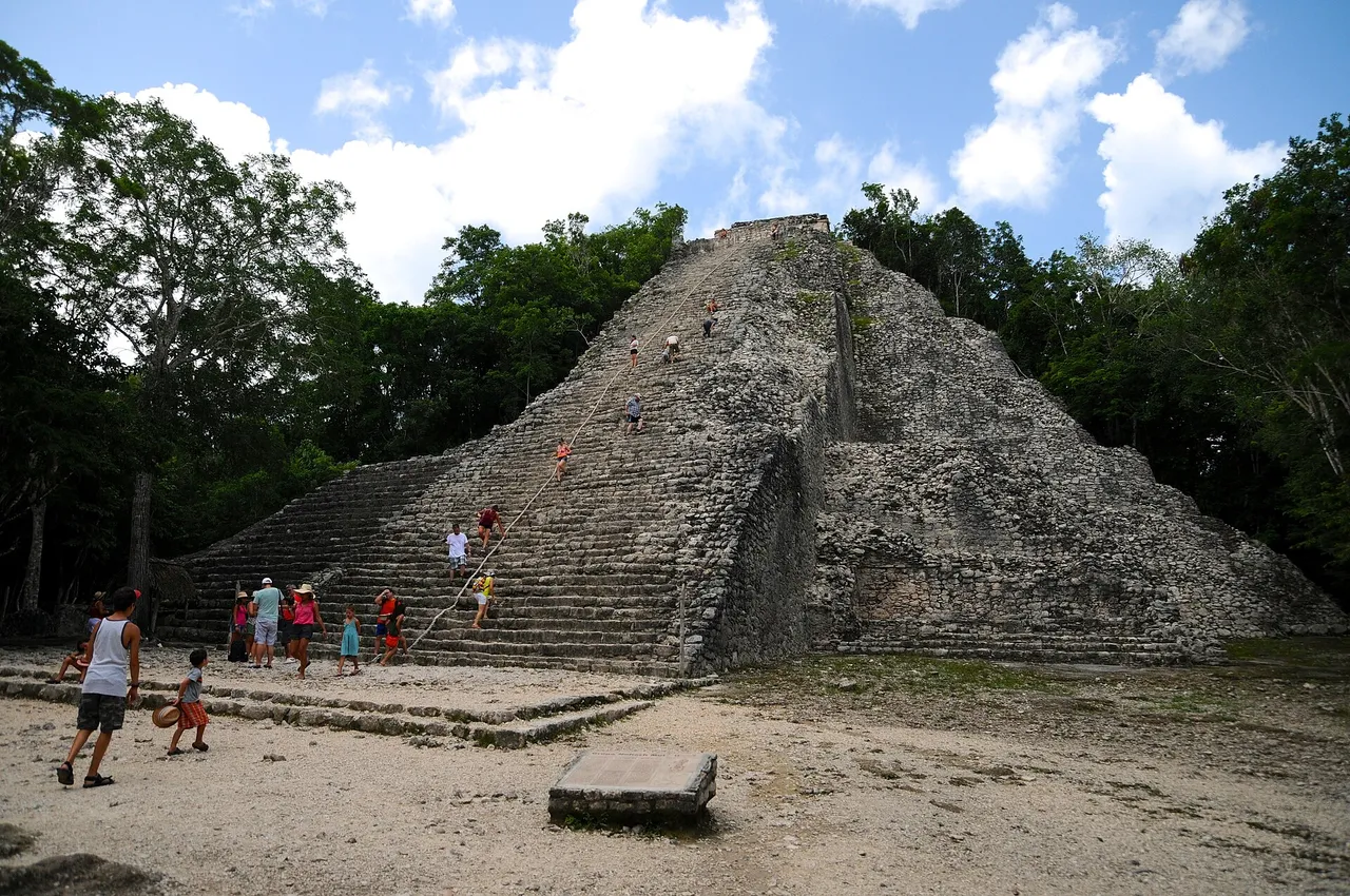 Cobá's Nohoch Mul pyramid seen from the base in 2013, with visitors on the old stone steps
