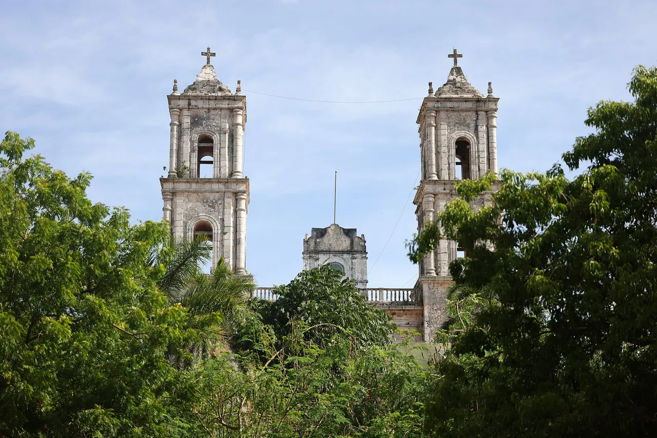 The twin towers of San Servacio church in Valladolid framed by trees