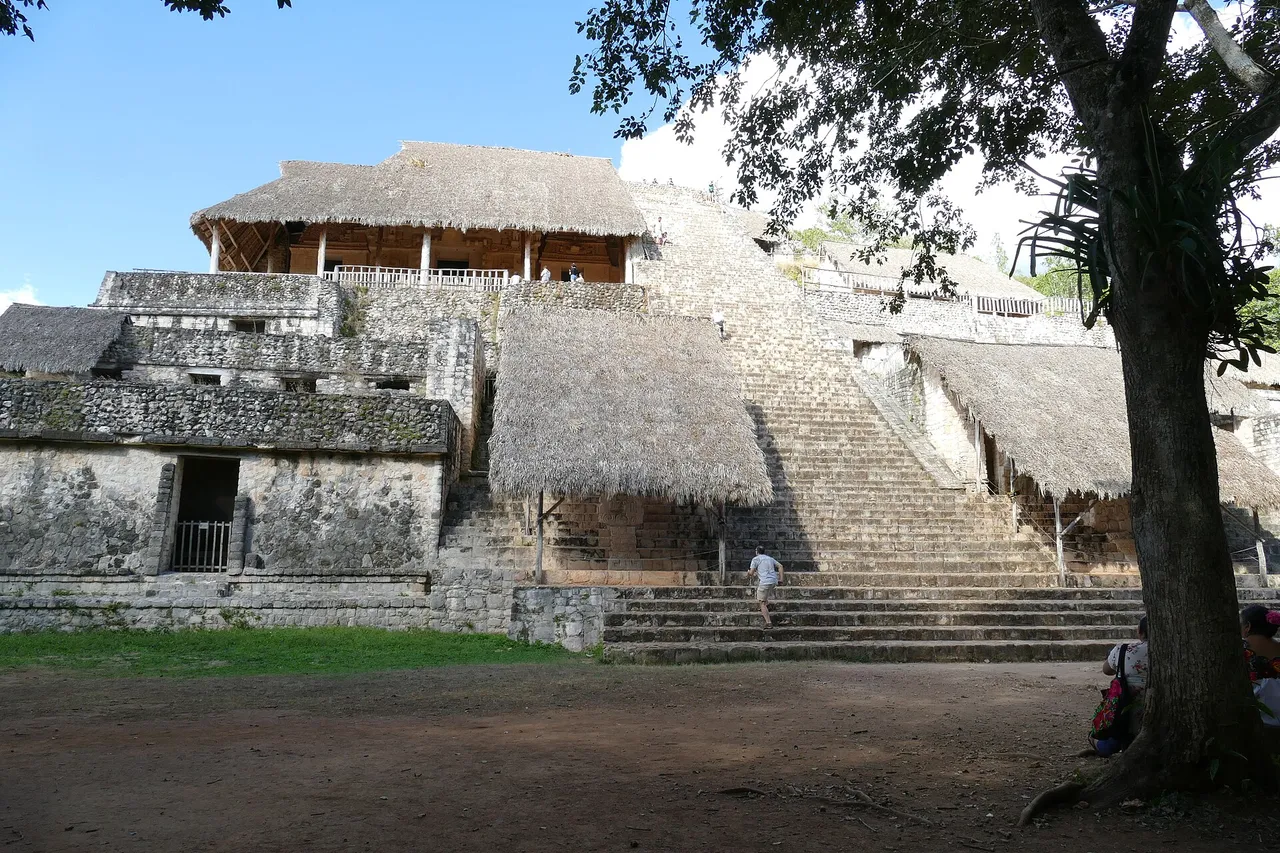 Stairway of the Ek Balam Acropolis with thatched shelters protecting the stucco reliefs